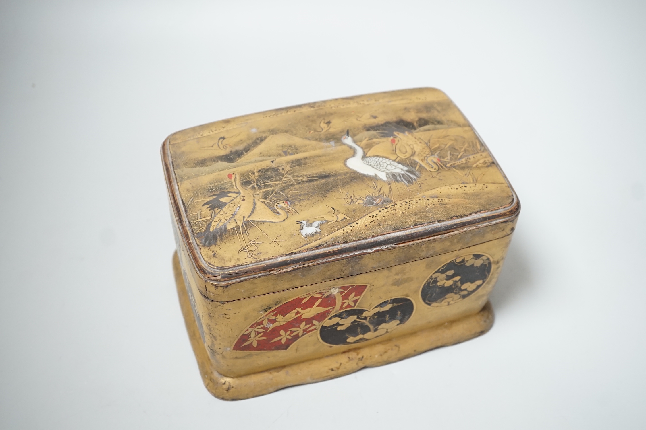 A Japanese lacquered box and cover accommodating a small collection of seashells